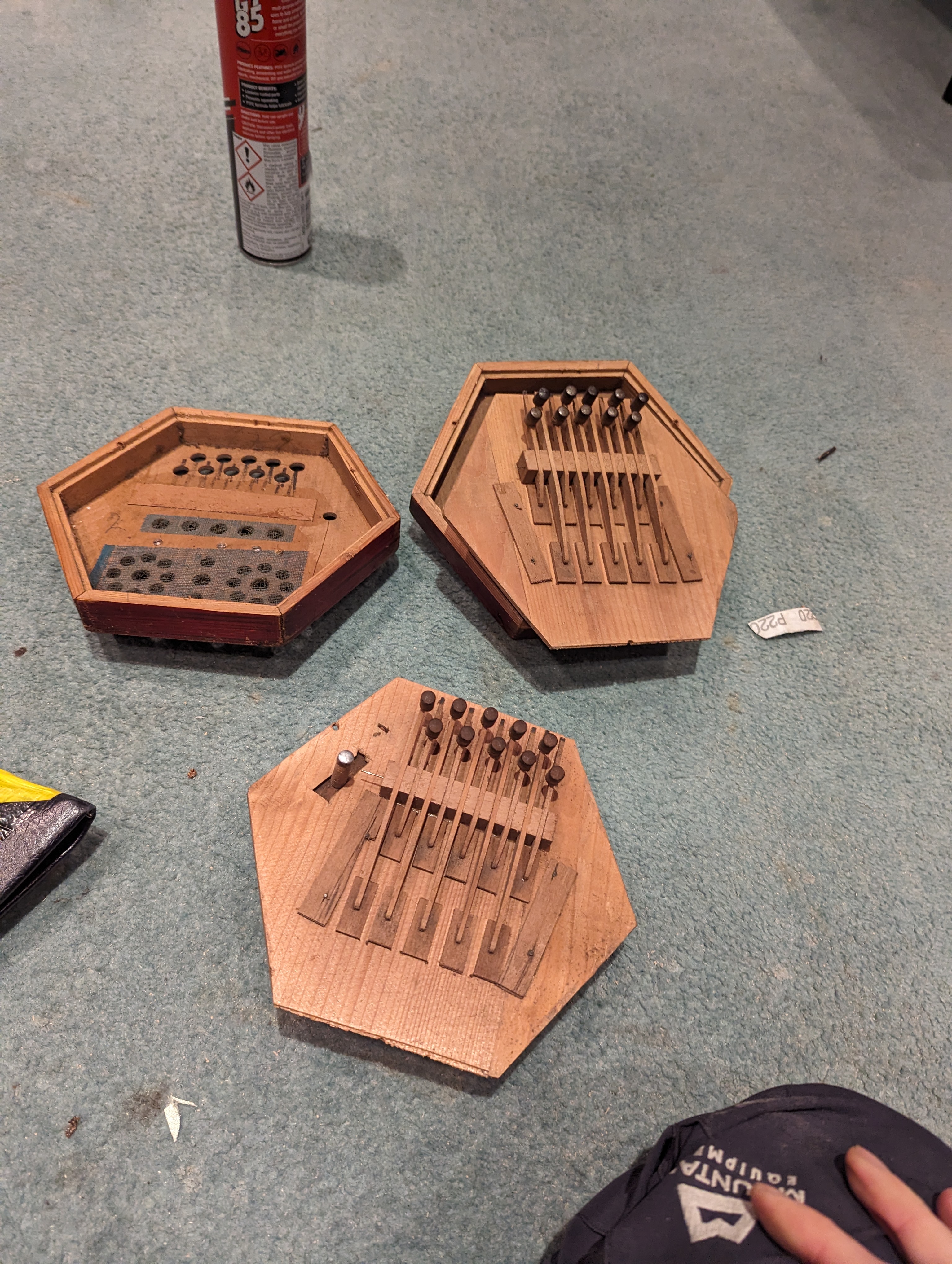The concertina taken apart, showing the wooden valve plates and reeds.